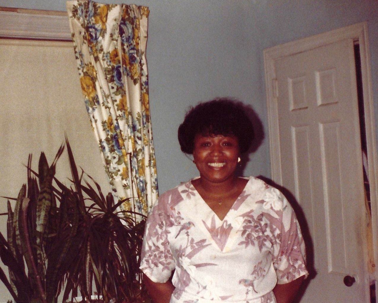 Elder Jessie Darrough standing in her home